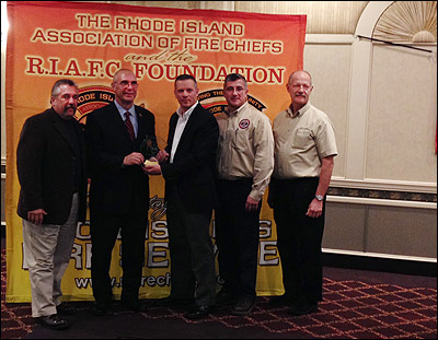 The NFFF Seal of Excellence Award is presented to the Rhode Island Fire Chiefs Association during their December meeting and holiday party. From left: Chief Ronald J. Siarnicki, executive director, NFFF; Chief Richard Susi, executive director, RIFCA; Chief Brian Jackvony, president, RIFCA; Victor Stagnaro, director of Fire Service Programs, NFFF; and Rick Mason, training and education coordinator, NFFF.